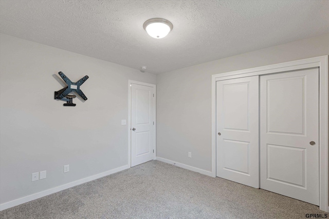 17312 Potter St, Bennington, NE 68005 - unfurnished bedroom with light carpet, baseboards, a textured ceiling, and a closet