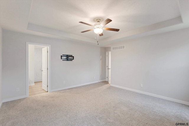 17312 Potter St, Bennington, NE 68005 - empty room with a raised ceiling, ceiling fan, light colored carpet, and baseboards