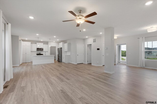 17312 Potter St, Bennington, NE 68005 - unfurnished living room featuring ceiling fan, light wood-style floors, baseboards, and recessed lighting