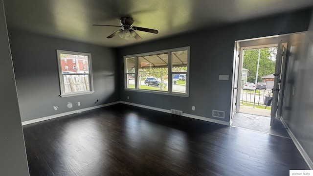 5218 Boyd St, Omaha, NE 68104 - spare room featuring dark wood-style floors, a ceiling fan, and baseboards