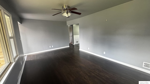 5218 Boyd St, Omaha, NE 68104 - spare room featuring baseboards, a ceiling fan, and dark wood finished floors