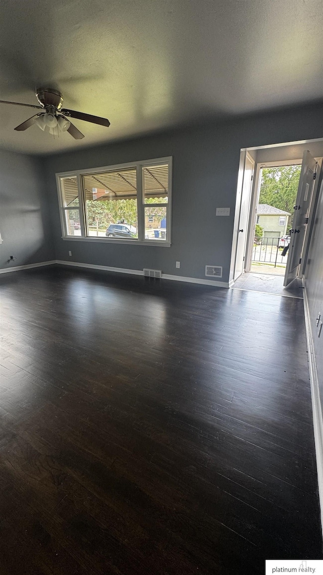 5218 Boyd St, Omaha, NE 68104 - unfurnished room featuring dark wood-type flooring, baseboards, and ceiling fan