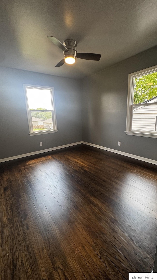 5218 Boyd St, Omaha, NE 68104 - spare room featuring dark wood-style floors, baseboards, and ceiling fan