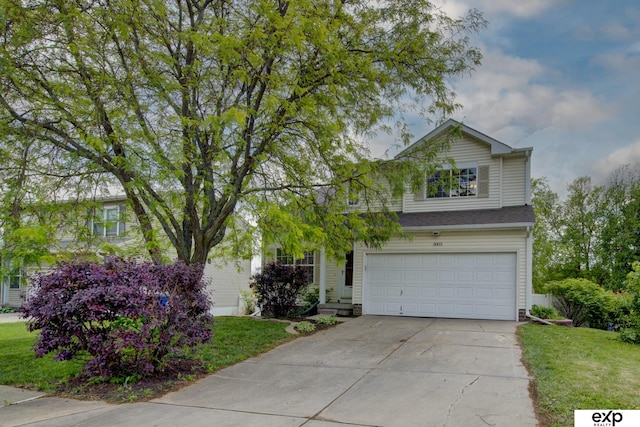 3003 Sheridan Rd, Bellevue, NE 68123 - view of front of home with an attached garage, concrete driveway, and a front yard