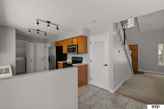 3003 Sheridan Rd, Bellevue, NE 68123 - kitchen featuring stainless steel appliances, washer / clothes dryer, light tile patterned flooring, light countertops, and baseboards