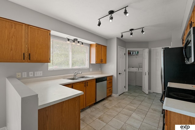 3003 Sheridan Rd, Bellevue, NE 68123 - kitchen with appliances with stainless steel finishes, independent washer and dryer, a sink, light countertops, and brown cabinetry