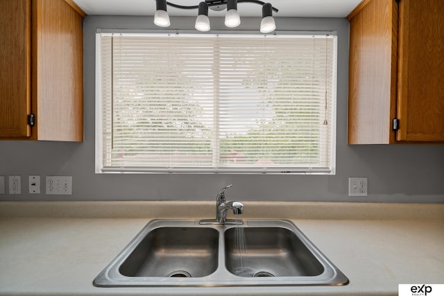3003 Sheridan Rd, Bellevue, NE 68123 - kitchen featuring a sink, brown cabinets, and light countertops