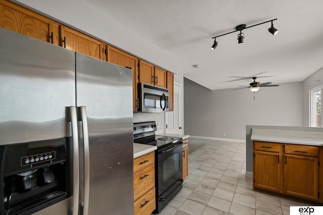 3003 Sheridan Rd, Bellevue, NE 68123 - kitchen featuring stainless steel appliances, a ceiling fan, brown cabinets, light countertops, and baseboards