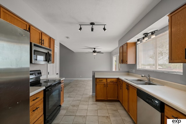 3003 Sheridan Rd, Bellevue, NE 68123 - kitchen with stainless steel appliances, a sink, light countertops, and a ceiling fan
