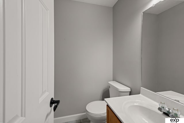 3003 Sheridan Rd, Bellevue, NE 68123 - half bathroom with toilet, vanity, baseboards, and tile patterned floors