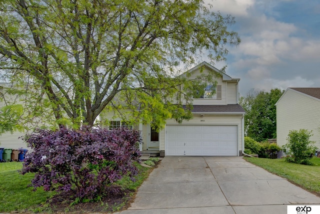 3003 Sheridan Rd, Bellevue, NE 68123 - view of front of house with an attached garage, concrete driveway, and a front lawn