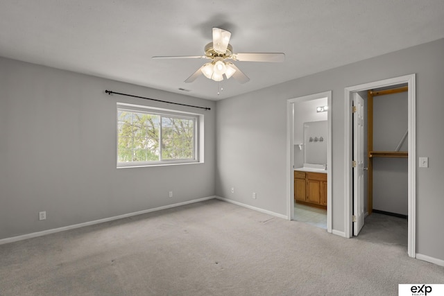 3003 Sheridan Rd, Bellevue, NE 68123 - unfurnished bedroom featuring light colored carpet, a walk in closet, baseboards, ensuite bath, and a closet