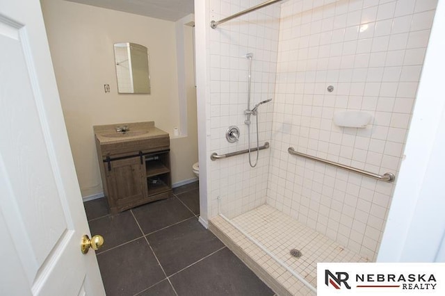 1801 Euclid Ave, Lincoln, NE 68502 - bathroom featuring a shower stall, vanity, tile patterned flooring, and toilet