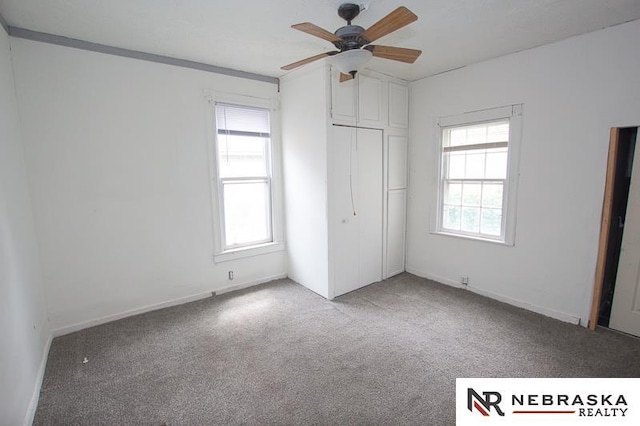 1801 Euclid Ave, Lincoln, NE 68502 - unfurnished bedroom featuring carpet flooring, a closet, baseboards, and ceiling fan