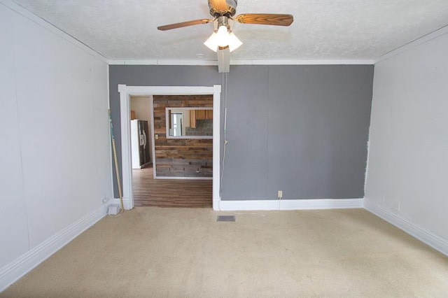 1801 Euclid Ave, Lincoln, NE 68502 - carpeted spare room with a textured ceiling, crown molding, baseboards, and ceiling fan