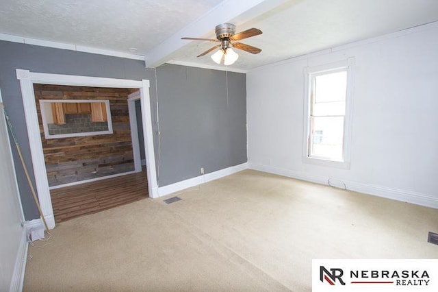 1801 Euclid Ave, Lincoln, NE 68502 - empty room featuring a ceiling fan, crown molding, light carpet, baseboards, and beamed ceiling