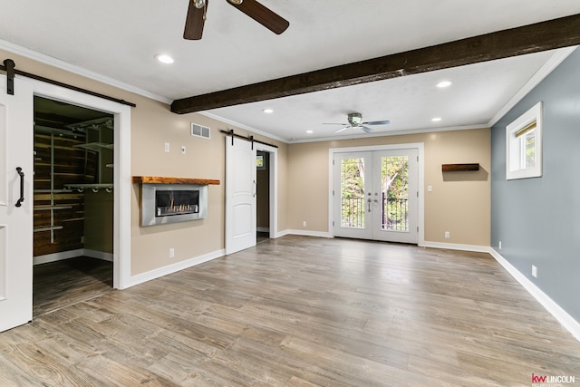 1305 S 4th Ave, Beatrice, NE 68310 - unfurnished living room featuring a barn door, ceiling fan, crown molding, wood finished floors, and beam ceiling