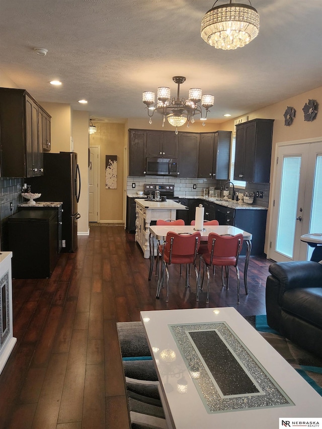16228 Virginia St, Omaha, NE 68136 - dining area with a chandelier, dark wood-style floors, and recessed lighting