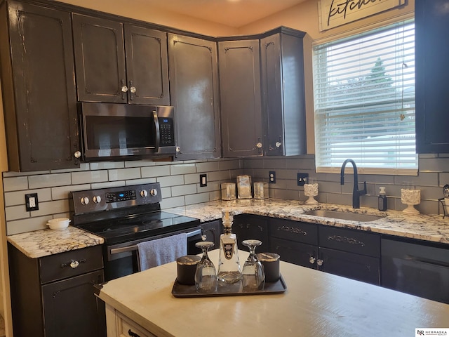 16228 Virginia St, Omaha, NE 68136 - kitchen featuring stainless steel microwave, a sink, electric range oven, tasteful backsplash, and dark brown cabinetry