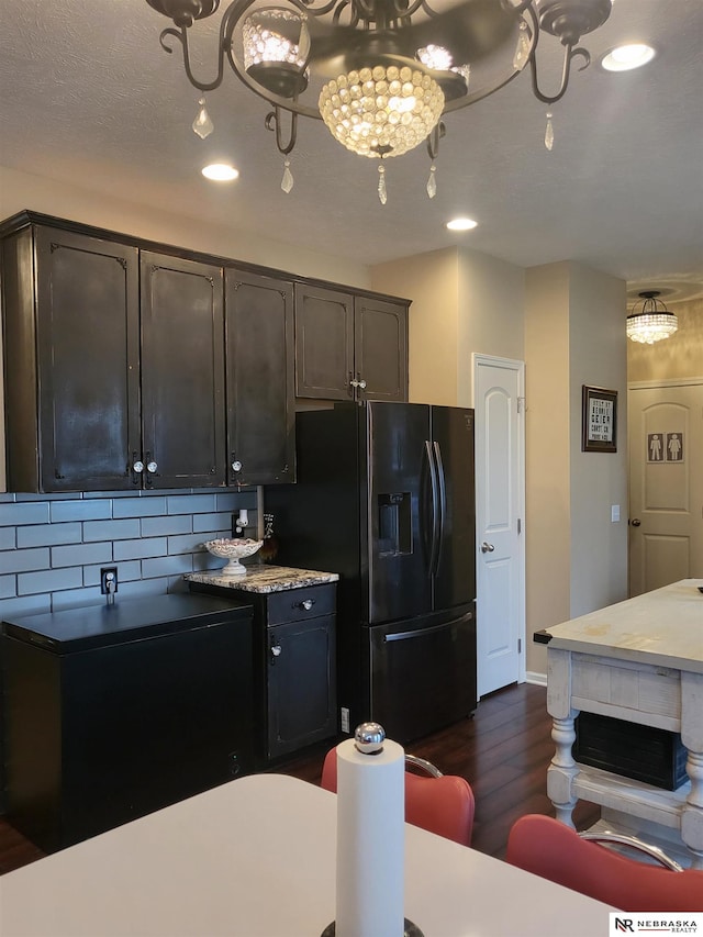 16228 Virginia St, Omaha, NE 68136 - kitchen with fridge with ice dispenser, dark wood-style floors, tasteful backsplash, recessed lighting, and dark brown cabinetry