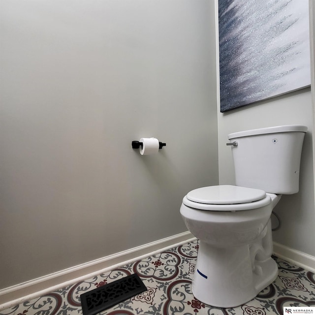 16228 Virginia St, Omaha, NE 68136 - bathroom featuring baseboards, toilet, and tile patterned flooring