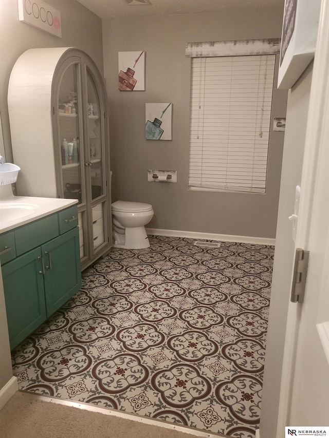 16228 Virginia St, Omaha, NE 68136 - bathroom with vanity, baseboards, and toilet