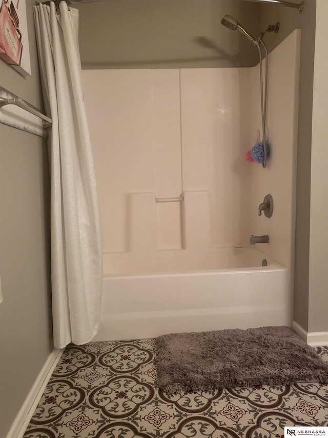 16228 Virginia St, Omaha, NE 68136 - full bathroom featuring shower / bath combo with shower curtain and baseboards