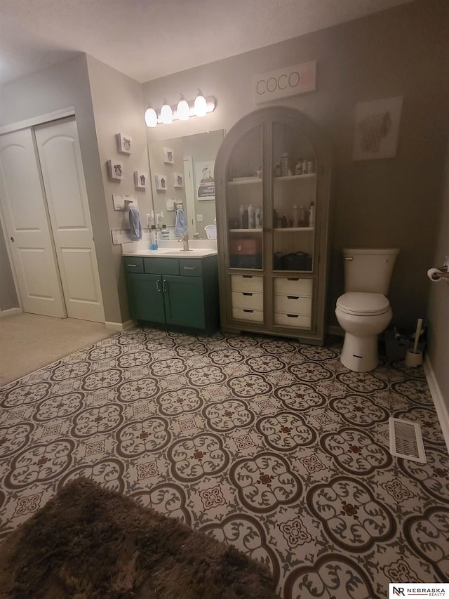 16228 Virginia St, Omaha, NE 68136 - bathroom with toilet, baseboards, and vanity