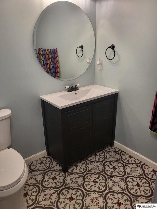16228 Virginia St, Omaha, NE 68136 - bathroom with baseboards, toilet, and vanity