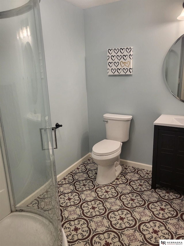 16228 Virginia St, Omaha, NE 68136 - full bath with baseboards, vanity, toilet, a stall shower, and tile patterned flooring