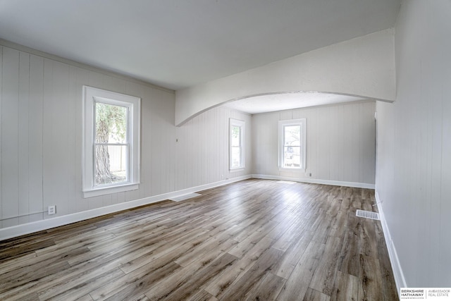 1943 Washington St, Blair, NE 68008 - empty room featuring arched walkways, healthy amount of natural light, and wood finished floors