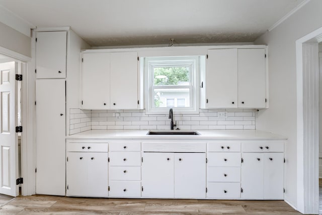 1943 Washington St, Blair, NE 68008 - kitchen with a sink, decorative backsplash, and white cabinets