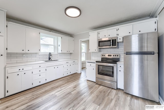 1943 Washington St, Blair, NE 68008 - kitchen featuring stainless steel appliances, a sink, light countertops, and tasteful backsplash