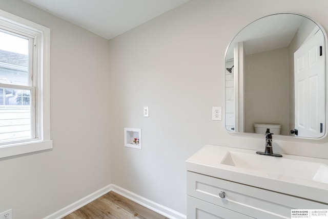 1943 Washington St, Blair, NE 68008 - washroom featuring hookup for a washing machine, light wood finished floors, baseboards, and arched walkways