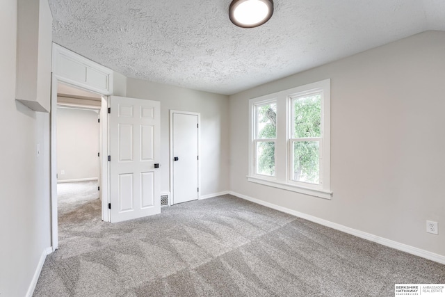 1943 Washington St, Blair, NE 68008 - unfurnished bedroom with carpet floors, baseboards, and a textured ceiling