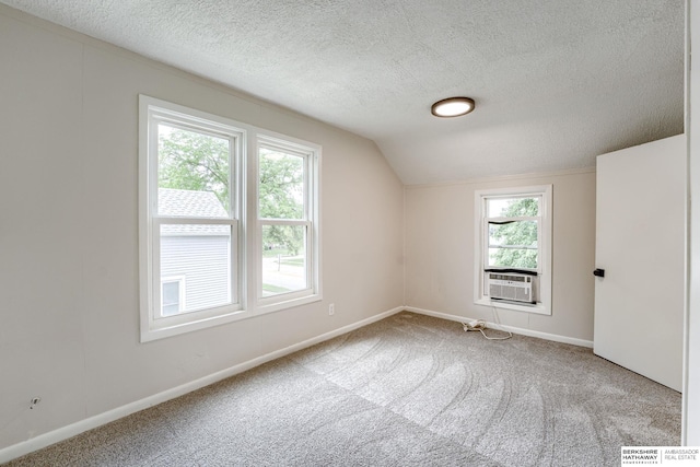 1943 Washington St, Blair, NE 68008 - additional living space featuring carpet, a textured ceiling, cooling unit, vaulted ceiling, and baseboards