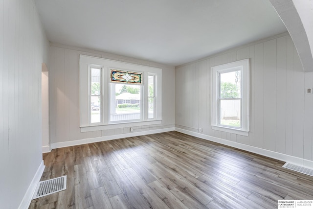 1943 Washington St, Blair, NE 68008 - unfurnished room with arched walkways, wood finished floors, and baseboards