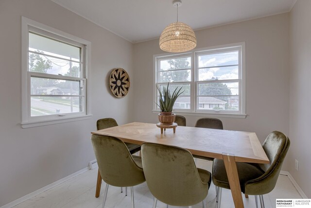 5002 S 77th Ave, Ralston, NE 68127 - dining area featuring plenty of natural light and baseboards