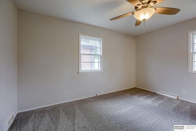 5002 S 77th Ave, Ralston, NE 68127 - unfurnished room featuring baseboard heating, carpet, ceiling fan, and baseboards