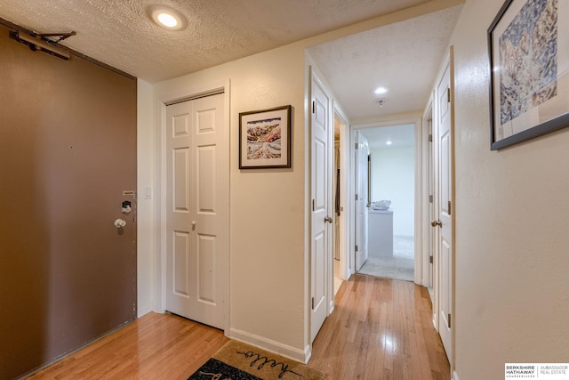 105 N 31st Ave Unit 502, Omaha, NE 68131 - corridor featuring light wood-type flooring, a textured ceiling, and baseboards