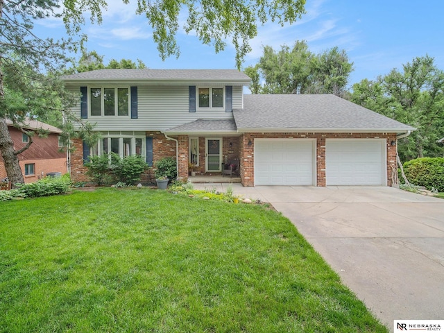 4112 Boulder Dr, Lincoln, NE 68516 - view of front facade with a garage, driveway, a front yard, brick siding, and roof with shingles