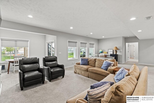 10317 S 191st Ave, Omaha, NE 68136 - living area featuring light carpet, recessed lighting, baseboards, and a textured ceiling
