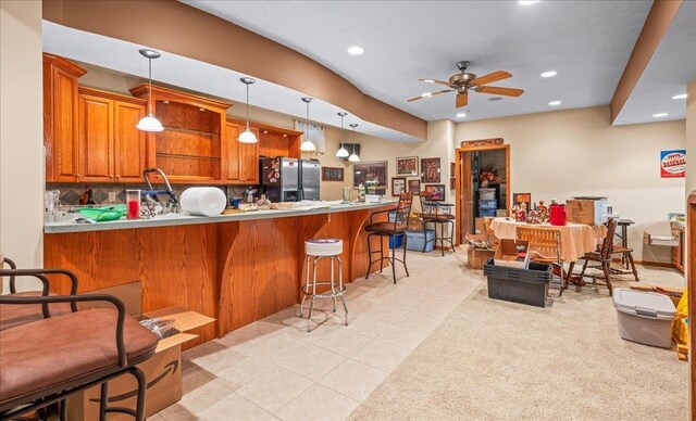 15102 Boyd St, Omaha, NE 68116 - kitchen with stainless steel refrigerator with ice dispenser, ceiling fan, brown cabinetry, a peninsula, and tasteful backsplash
