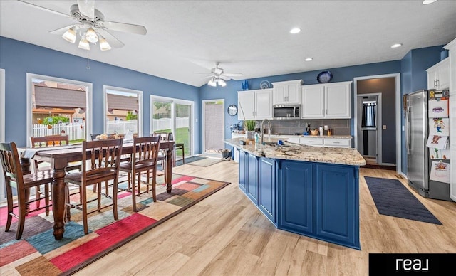 15102 Boyd St, Omaha, NE 68116 - kitchen featuring stainless steel appliances, ceiling fan, light wood-type flooring, white cabinetry, and recessed lighting