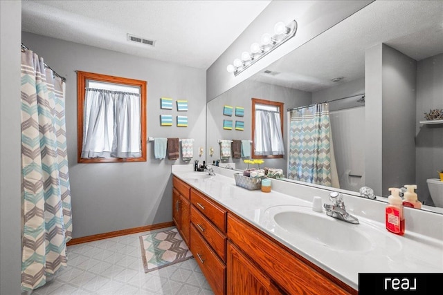 15102 Boyd St, Omaha, NE 68116 - bathroom featuring double vanity, tile patterned floors, baseboards, and a shower with curtain
