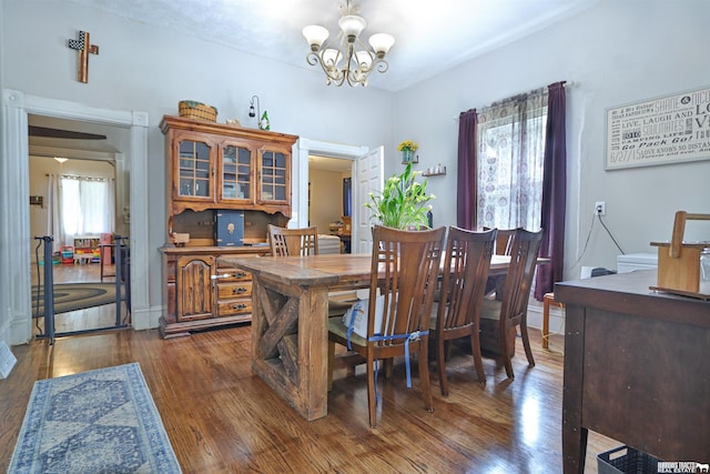 429 N 4th St, Tecumseh, NE 68450 - dining space featuring dark wood finished floors and a chandelier