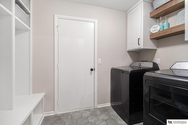 606 Pioneer Dr, Fort Calhoun, NE 68023 - washroom with cabinet space, separate washer and dryer, baseboards, a textured ceiling, and light tile patterned floors