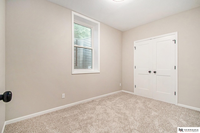 606 Pioneer Dr, Fort Calhoun, NE 68023 - unfurnished bedroom featuring carpet flooring, baseboards, and a closet
