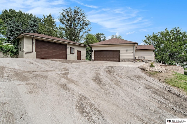 606 Pioneer Dr, Fort Calhoun, NE 68023 - view of front of property with a garage and an outbuilding
