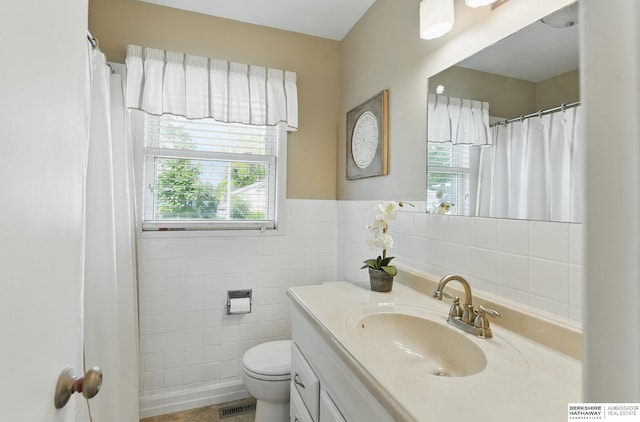 6641 S 85th St, Ralston, NE 68127 - full bath featuring tile walls, vanity, and toilet